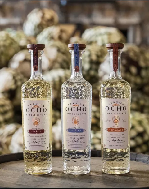 Tequila Ocho bottles on a barrel