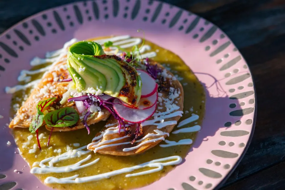 Tacos de papa with salsa, crema and avocado